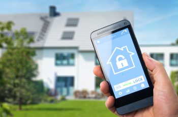smart house, home automation, device with app icons. Man uses his smartphone with smarthome security app to unlock the door of his house.